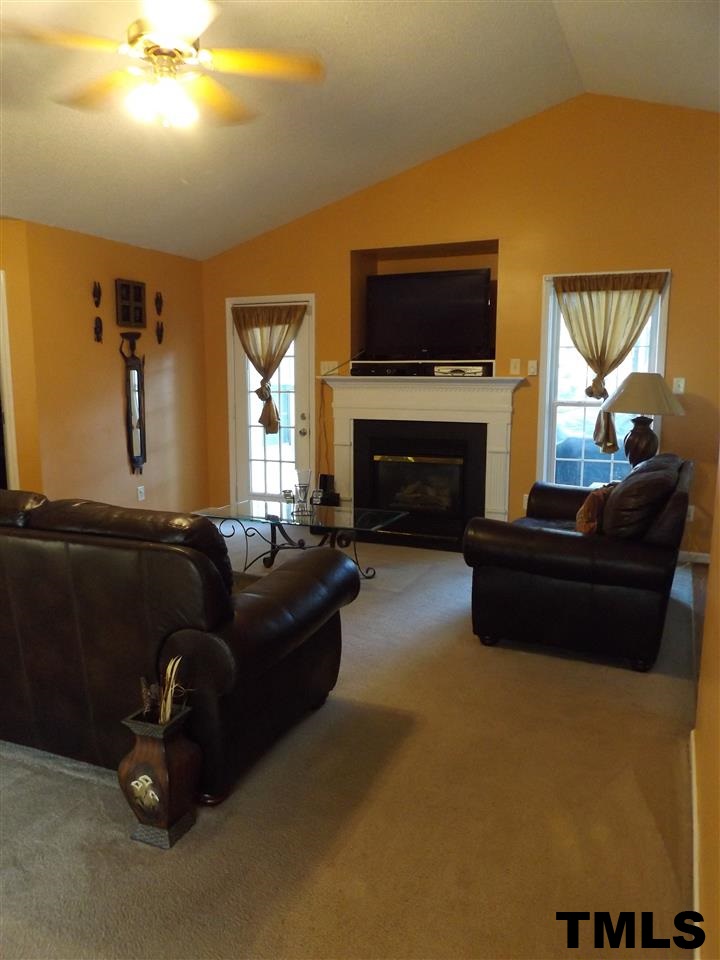 1905 Maybrook Drive Raleigh, NC 27610 - Photo 4 of 17 Spacious, with a ceiling fan, fireplace equipped with built-ins, and lots of sunlight!