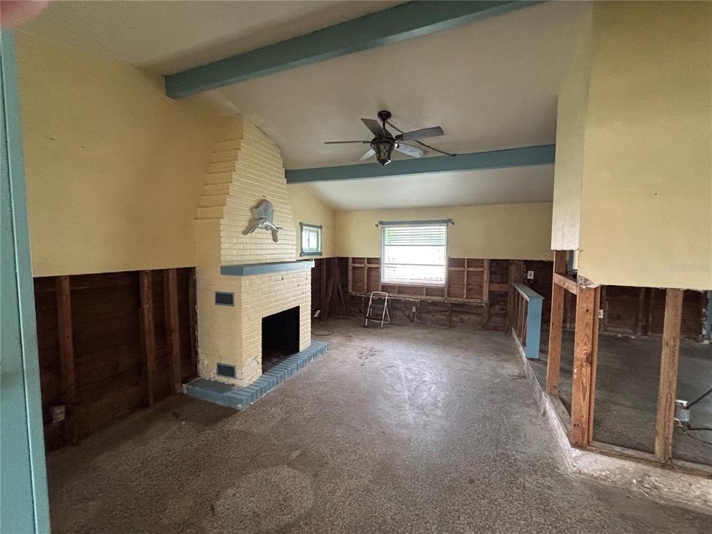 18006 4th Street East Redington Shores, FL 33708 - Photo 17 of 32 a view of a livingroom with a fireplace a window and a kitchen