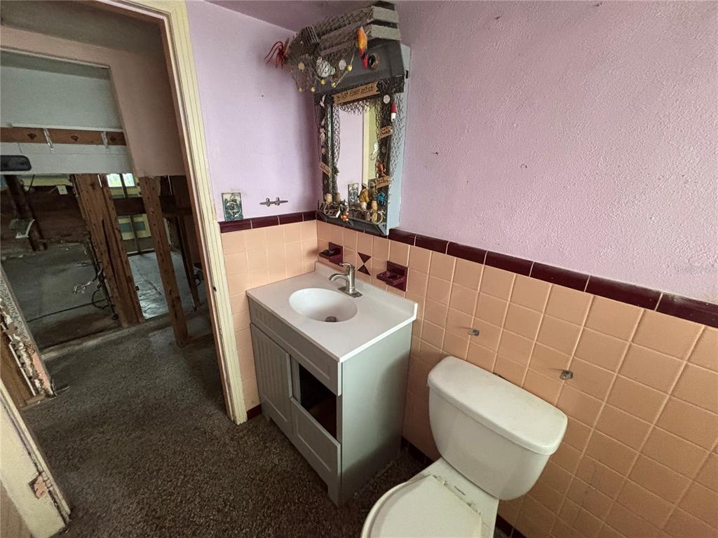 18006 4th Street East Redington Shores, FL 33708 - Photo 28 of 32 a white toilet sitting next to a bathroom sink