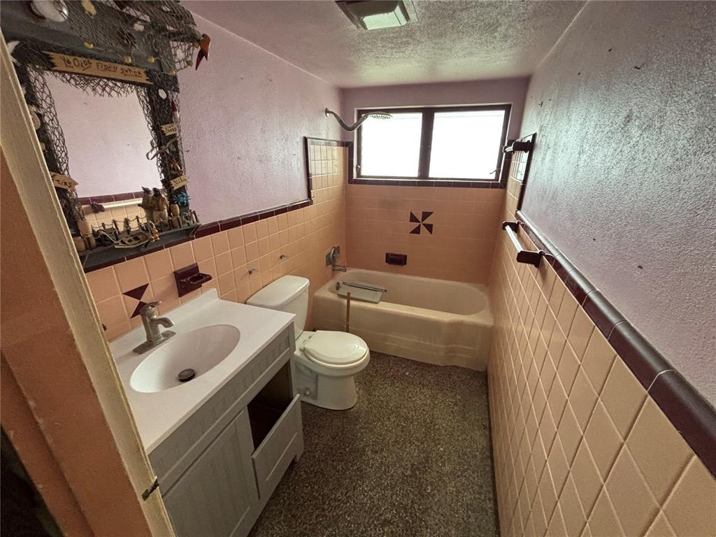 18006 4th Street East Redington Shores, FL 33708 - Photo 29 of 32 a bathroom with a sink a toilet and bathtub