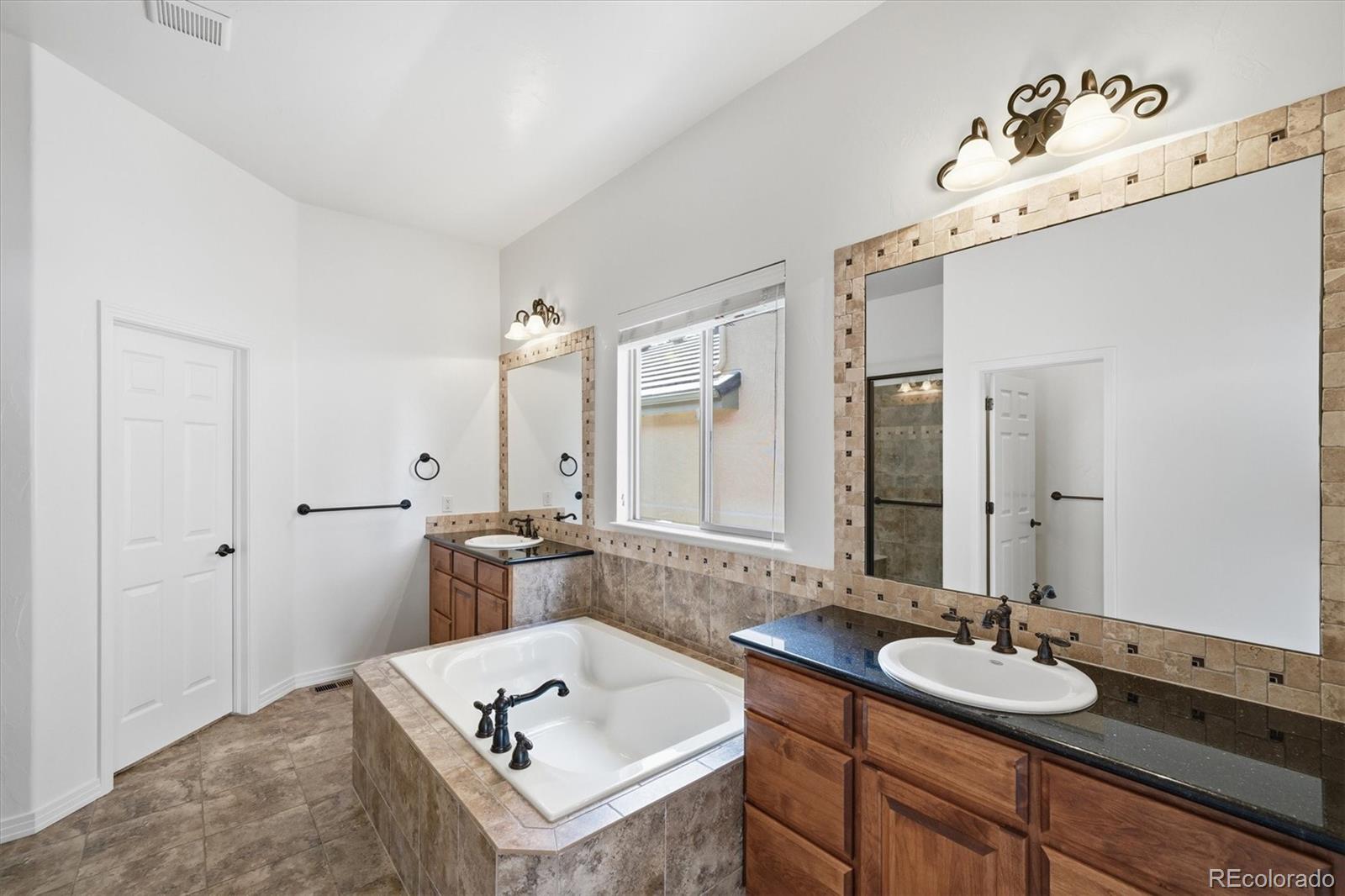477 Rifle Way Broomfield, CO 80020 - Photo 19 of 45 a bathroom with a sink and a mirror