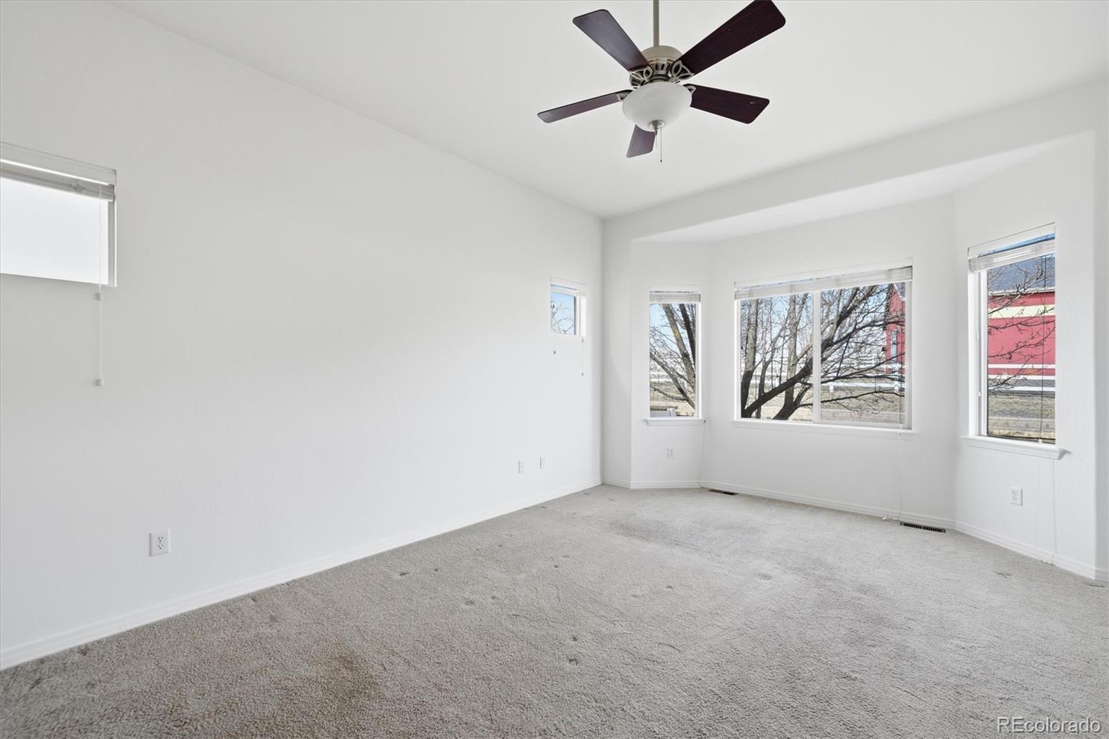 477 Rifle Way Broomfield, CO 80020 - Photo 24 of 45 an empty room with windows and fan