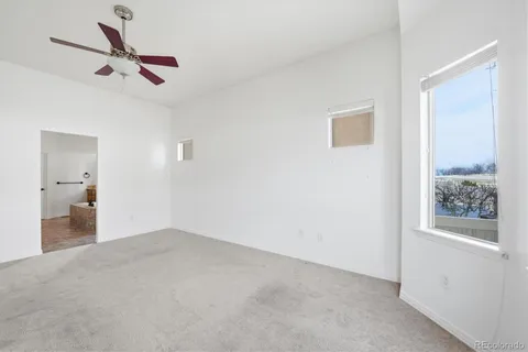 a view of a livingroom with a ceiling fan and window