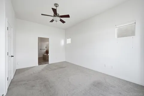 a view of a room with a ceiling fan