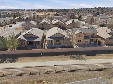 an aerial view of residential houses with outdoor space