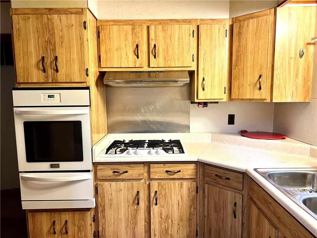 166 Tony Row Road Star Junction, PA 15482 - Photo 11 of 25 a kitchen with stainless steel appliances granite countertop a stove a sink and a microwave