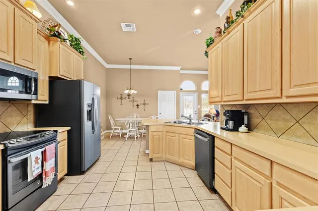 a kitchen with a sink a stove and refrigerator