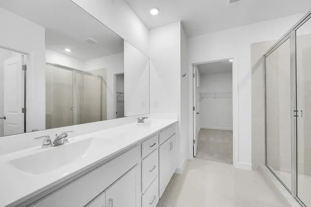 a bathroom with a double vanity sink mirror and double