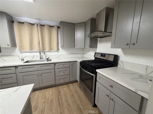 a kitchen with a sink stove and cabinets