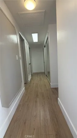 a view of hallway with wooden floor