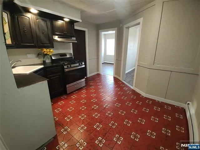 a kitchen with granite countertop sink and cabinets
