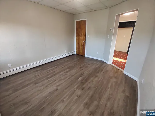 an empty room with wooden floor and closet