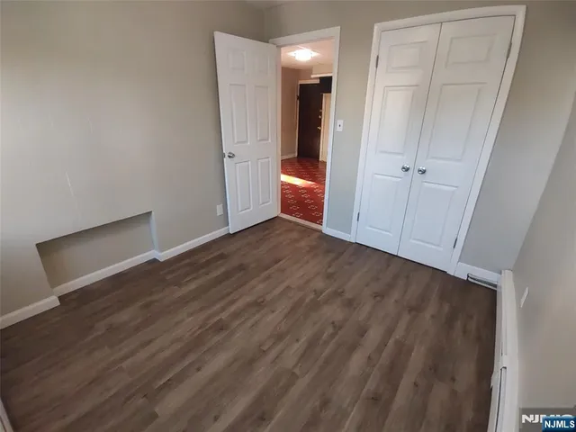 a view of a room with wooden floor and a sink