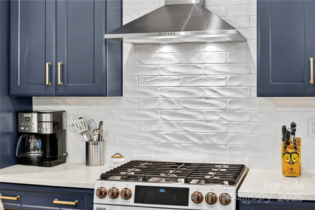 a stove top oven sitting inside of a kitchen