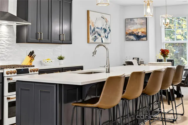 a dining table with chairs and cabinets