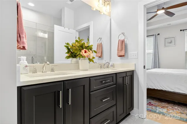 a bathroom with a sink double vanity and a mirror