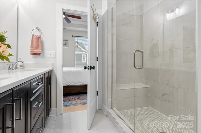 a en suite bathroom with a granite countertop sink a toilet and shower