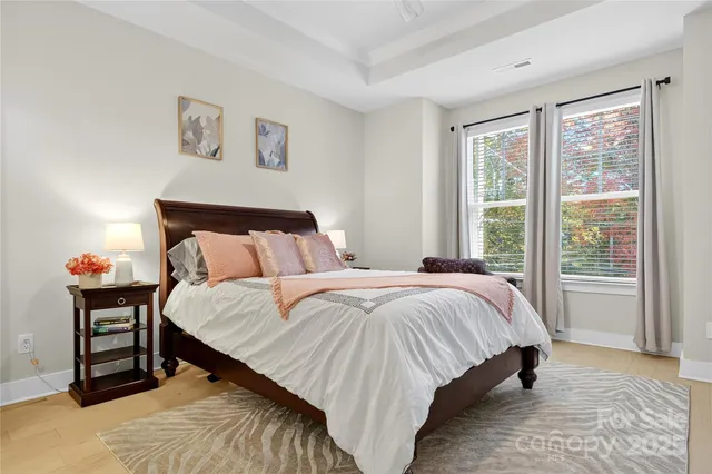 a bed sitting in a bedroom next to a window