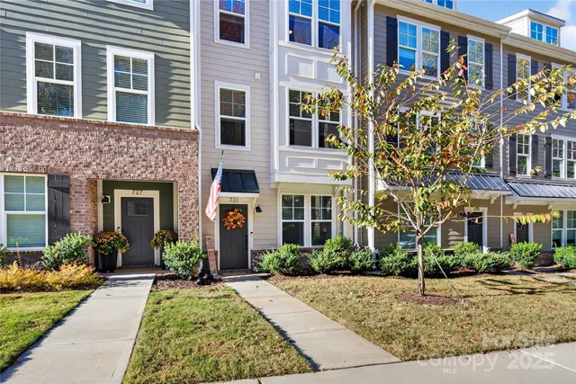 front view of a brick house with a small yard