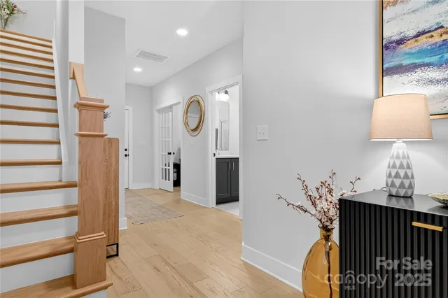 a view of a hallway with entryway wooden floor and front door