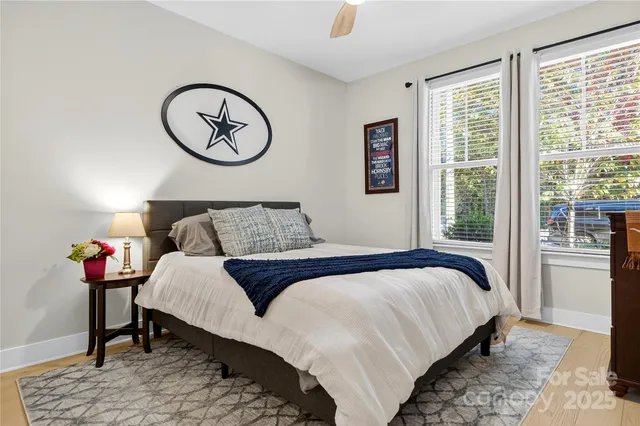 a bedroom with a bed a dresser and a window