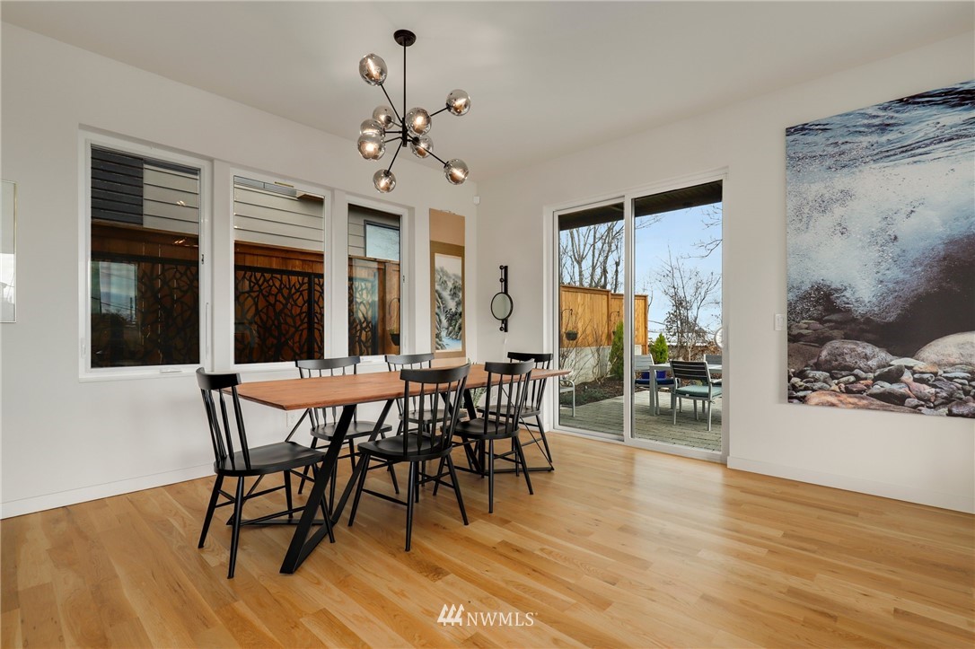 3740 34th Avenue Southwest Seattle, WA 98126 - Photo 12 of 31 a view of a dining room with furniture window and wooden floor