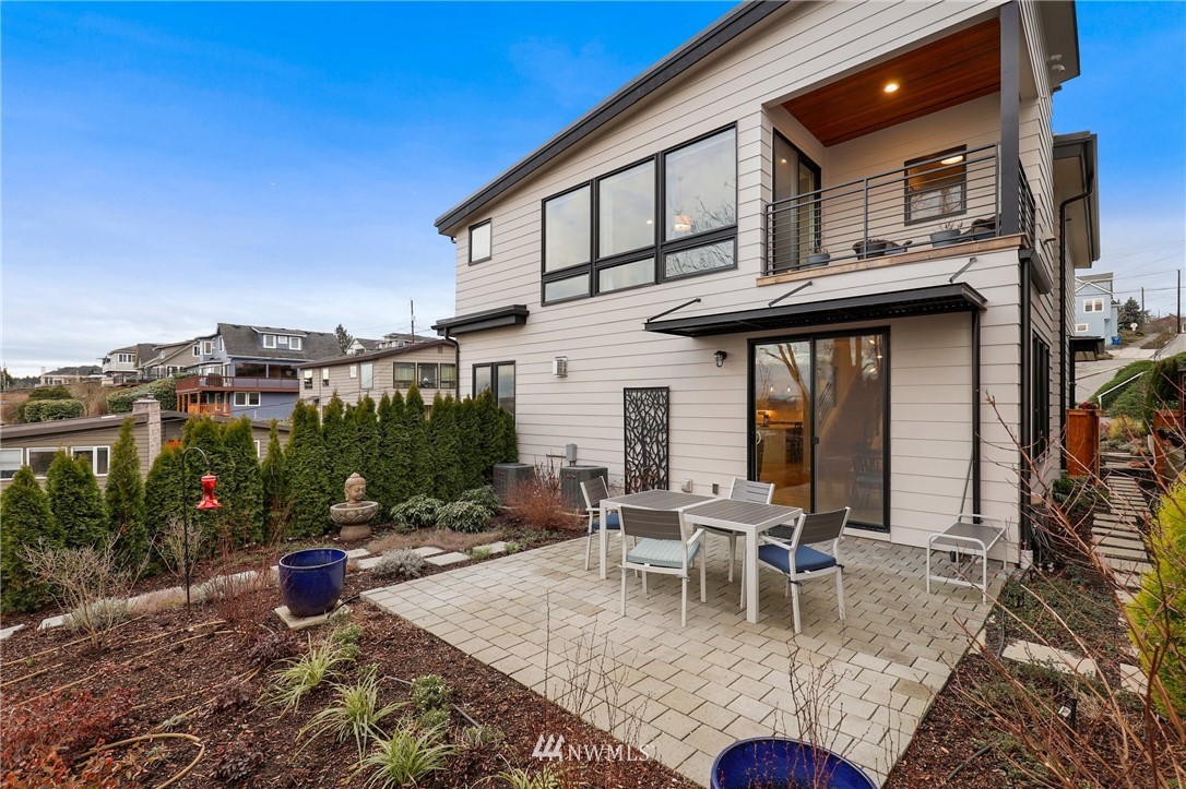 3740 34th Avenue Southwest Seattle, WA 98126 - Photo 13 of 31 a view of a patio with table and chairs potted plants and large tree