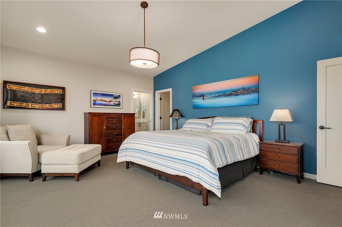 3740 34th Avenue Southwest Seattle, WA 98126 - Photo 17 of 31 a spacious bedroom with a bed and a lamp