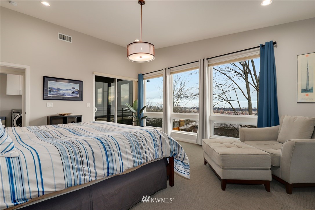 3740 34th Avenue Southwest Seattle, WA 98126 - Photo 18 of 31 a bedroom with a large bed and a large window