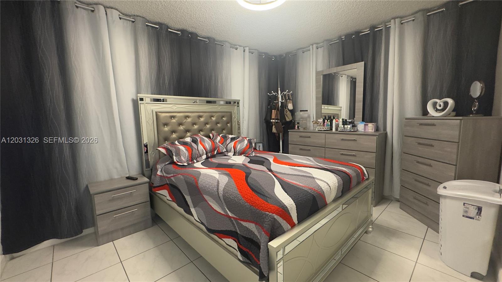 12480 Southwest 189th Street Miami, FL 33177 - Photo 10 of 25 a bed sitting in a bedroom next to a bathroom