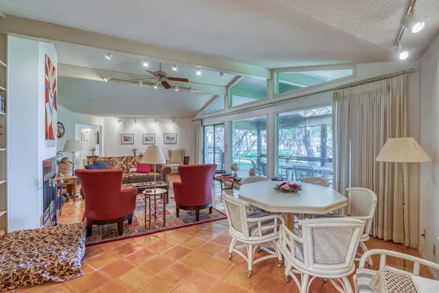 a living room filled with furniture and a large window
