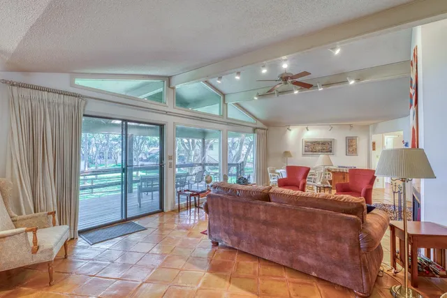 a bedroom with a bed a chandelier and a chair
