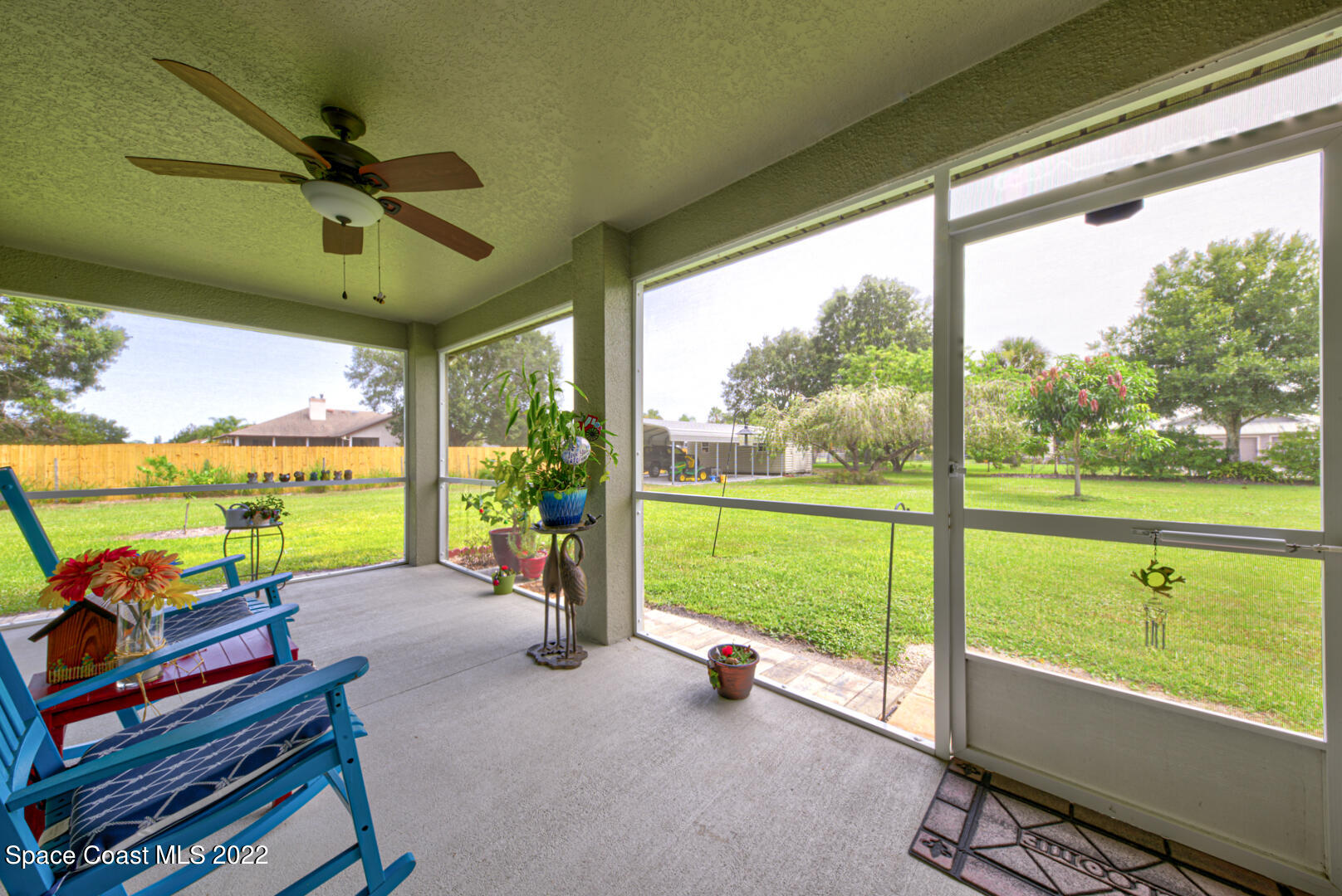 3945 Post Road Melbourne, FL 32934 - Photo 14 of 24 a view of a patio with a table chairs and a backyard