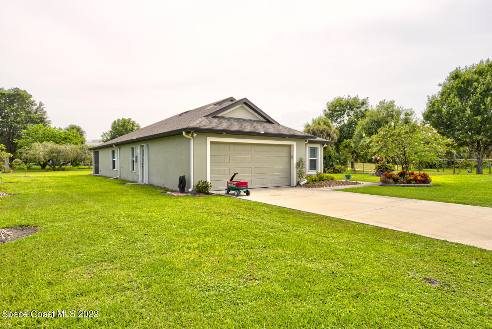 3945 Post Road Melbourne, FL 32934 - Photo 2 of 24 a front view of a house with a yard and garage