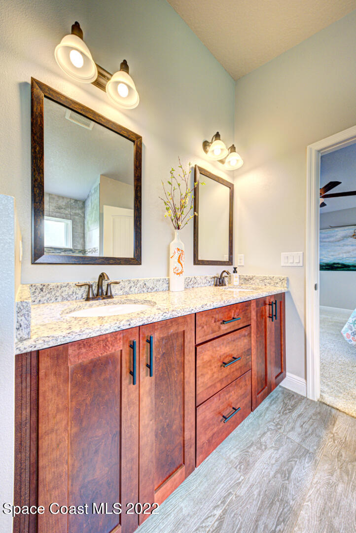 3945 Post Road Melbourne, FL 32934 - Photo 10 of 24 a bathroom with a granite countertop sink and a mirror