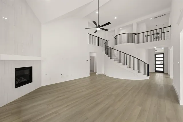 a view of staircase and living room with wooden floor