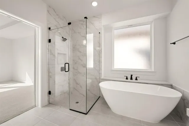 a white bath tub sitting next to a bathroom sink