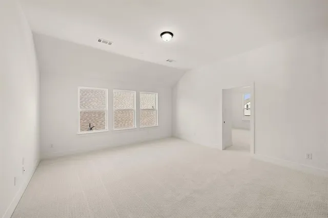 an empty room with a empty space and windows