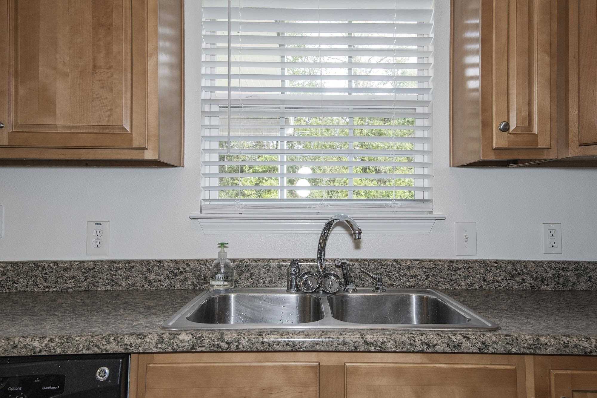 4608 Anna Simpson Road Milton, FL 32583 - Photo 11 of 22 a kitchen with granite countertop a sink and a window
