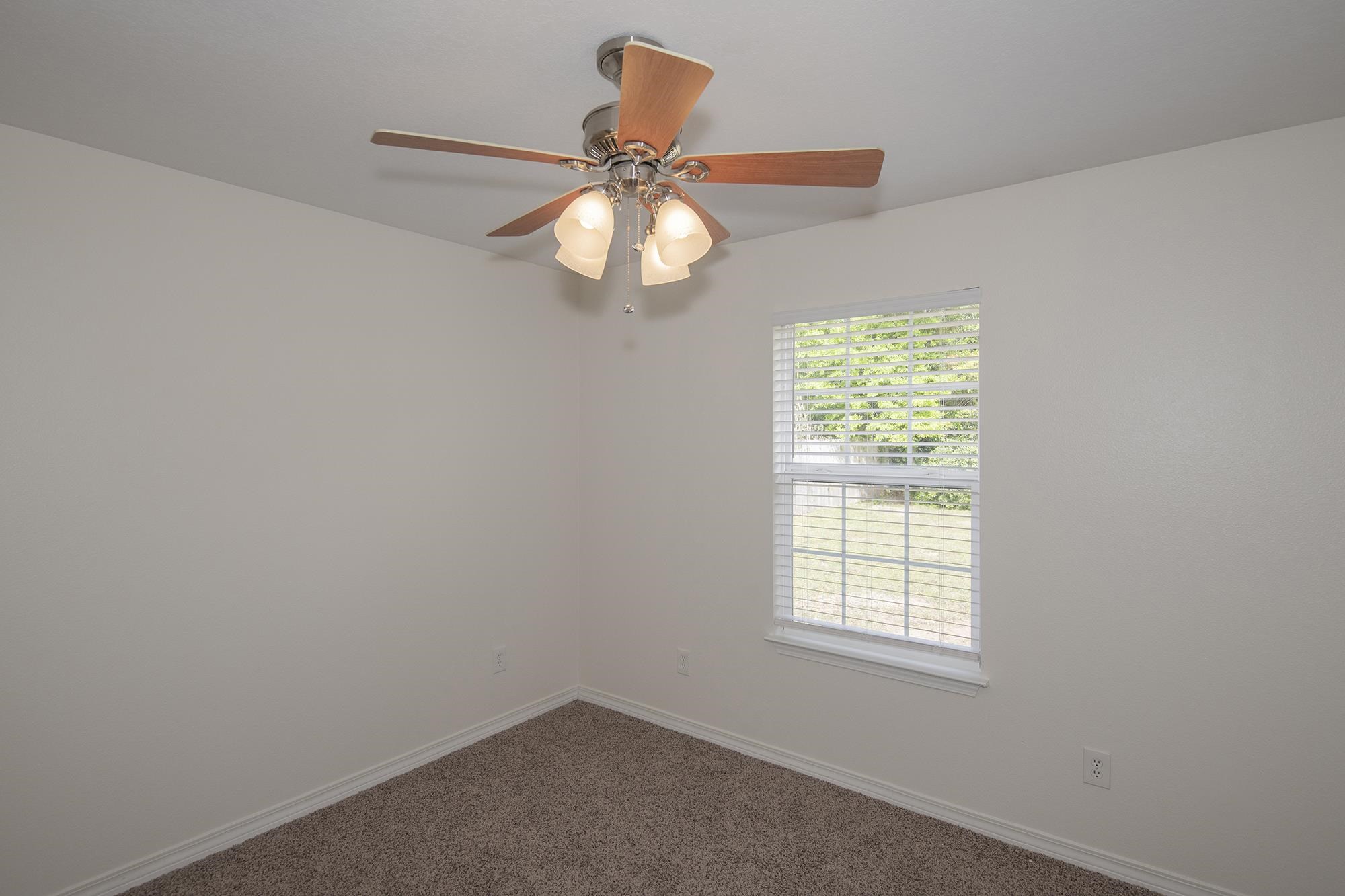 4608 Anna Simpson Road Milton, FL 32583 - Photo 13 of 22 an empty room with windows and fan