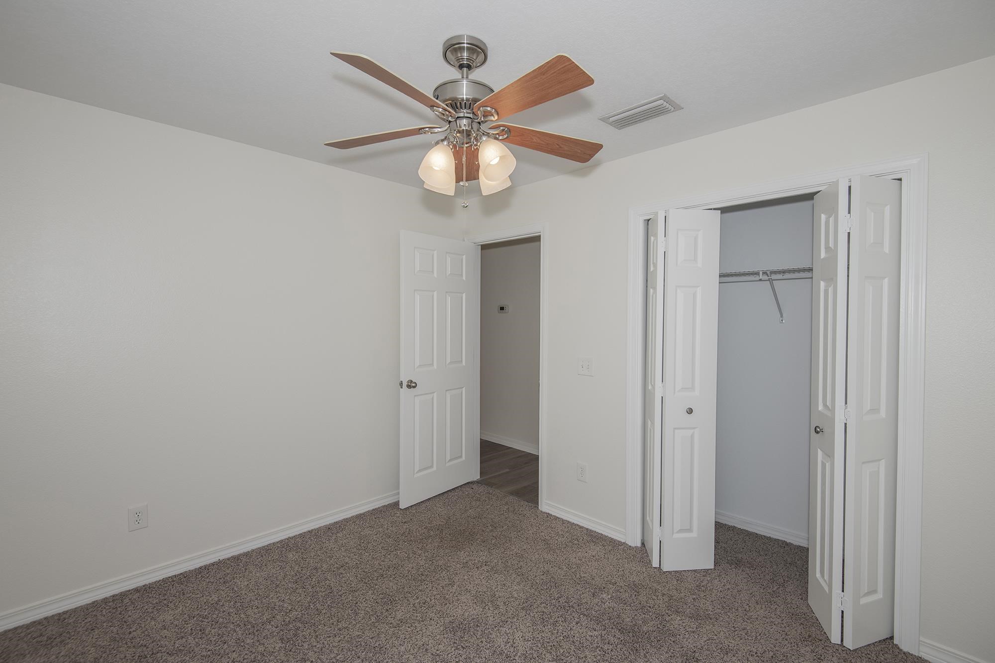 4608 Anna Simpson Road Milton, FL 32583 - Photo 15 of 22 an empty room with closet and fan
