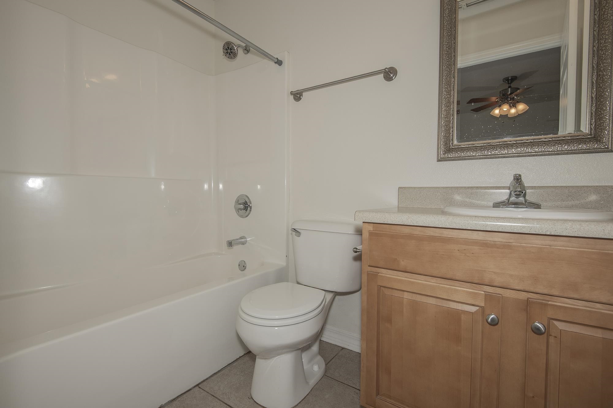 4608 Anna Simpson Road Milton, FL 32583 - Photo 21 of 22 a bathroom with a toilet sink and mirror