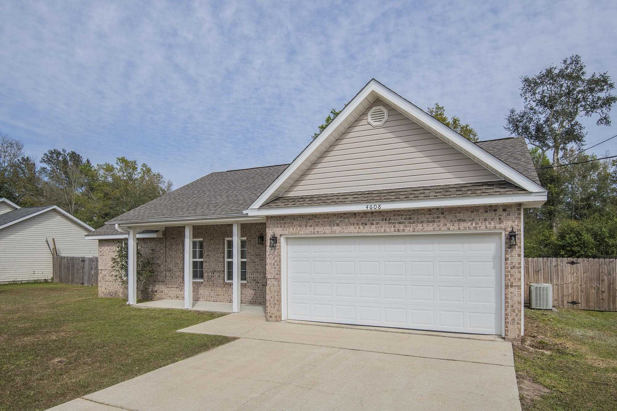 4608 Anna Simpson Road Milton, FL 32583 - Photo 3 of 22 a front view of a house with a garden and yard