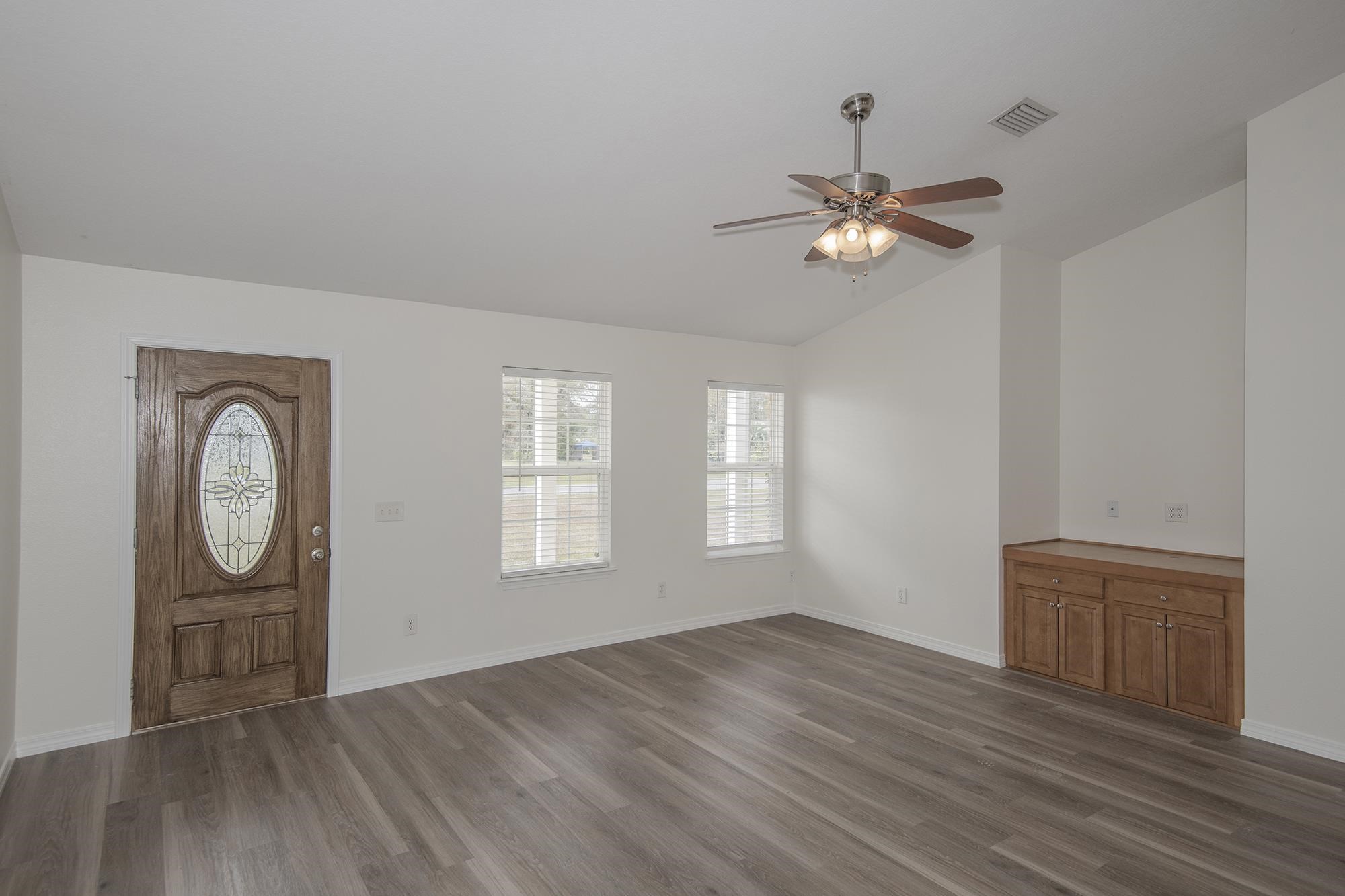 4608 Anna Simpson Road Milton, FL 32583 - Photo 5 of 22 a view of empty room with wooden floor and fan
