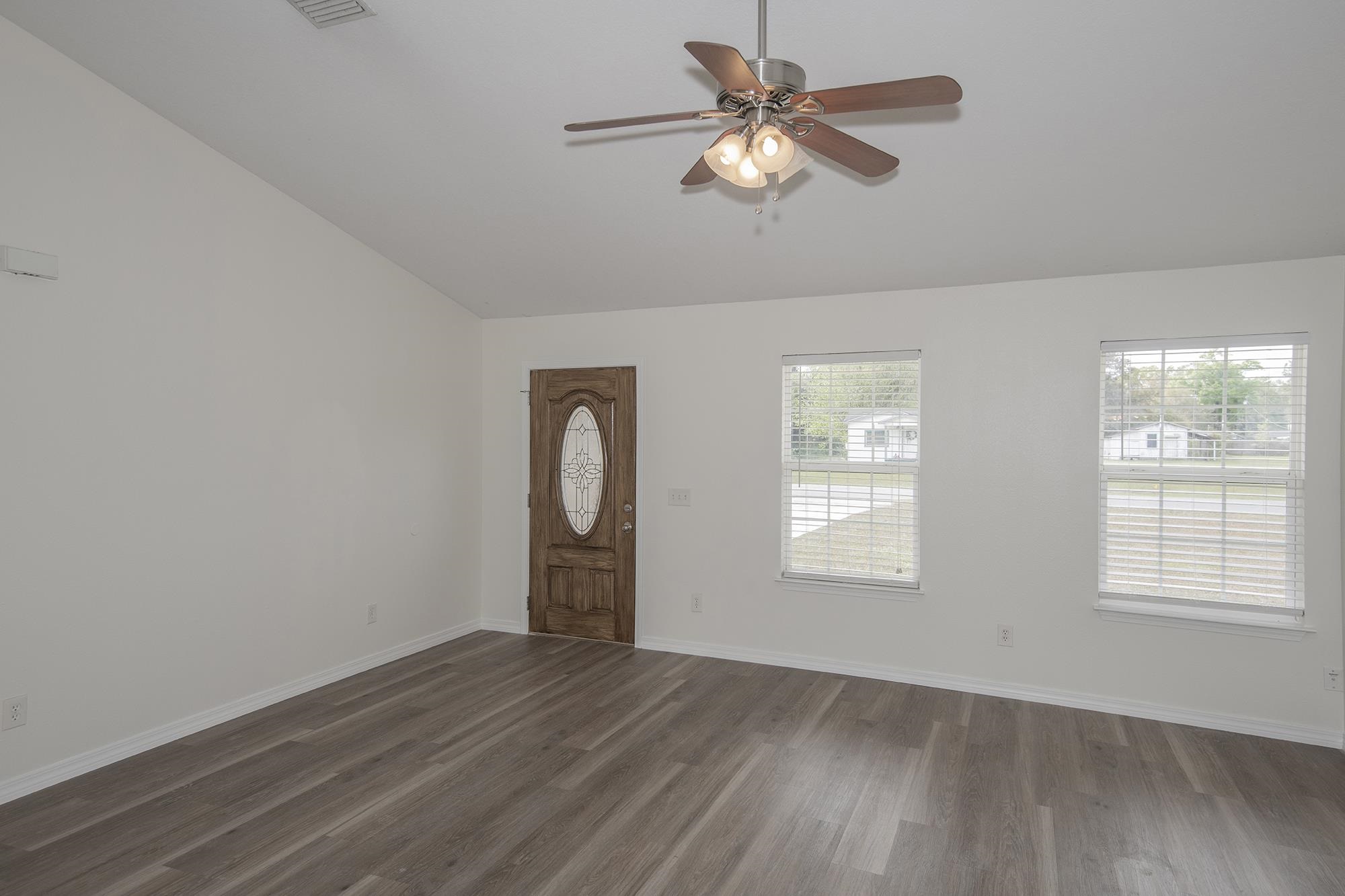 4608 Anna Simpson Road Milton, FL 32583 - Photo 6 of 22 a view of empty room with wooden floor and fan