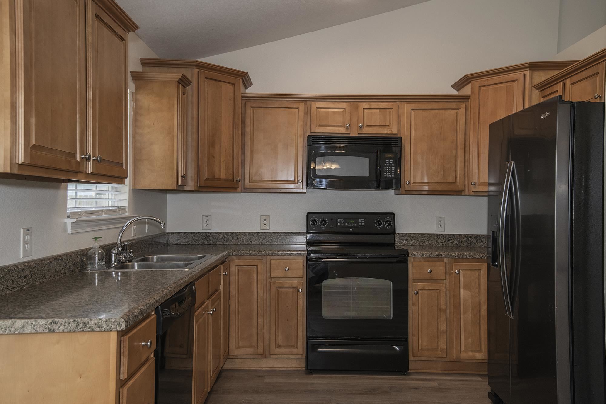 4608 Anna Simpson Road Milton, FL 32583 - Photo 8 of 22 a kitchen with a sink stove and refrigerator