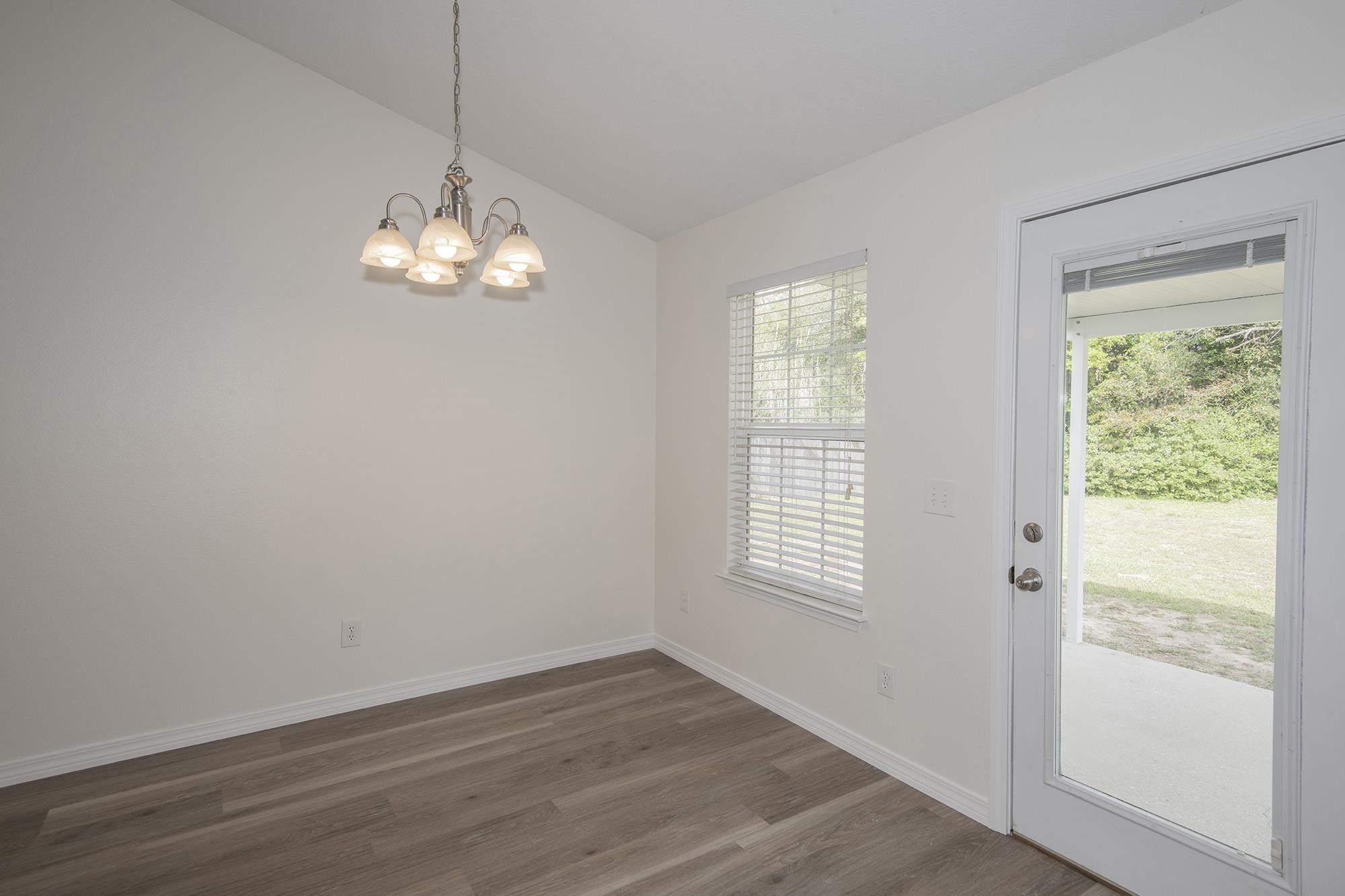 4608 Anna Simpson Road Milton, FL 32583 - Photo 10 of 22 an empty room with wooden floor and windows