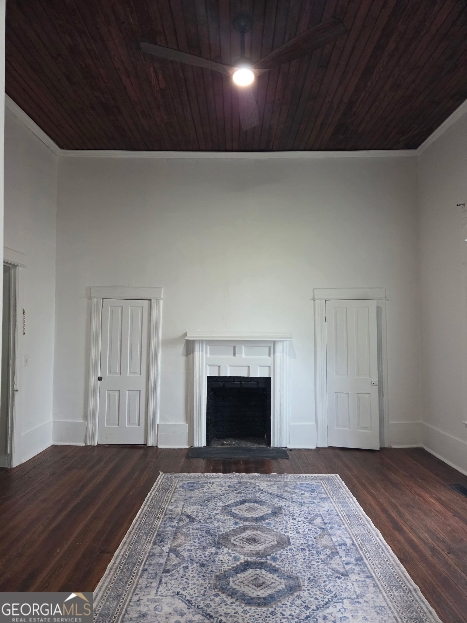 1907 Broad Street Statham, GA 30666 - Photo 12 of 20 a view of empty room with wooden floor and fireplace