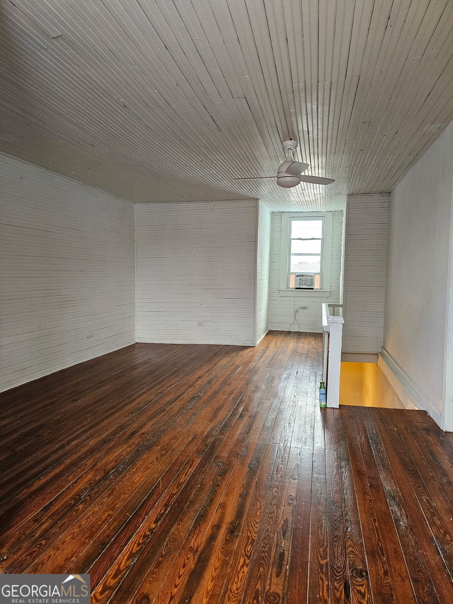 1907 Broad Street Statham, GA 30666 - Photo 16 of 20 a view of empty room with wooden floor and fan