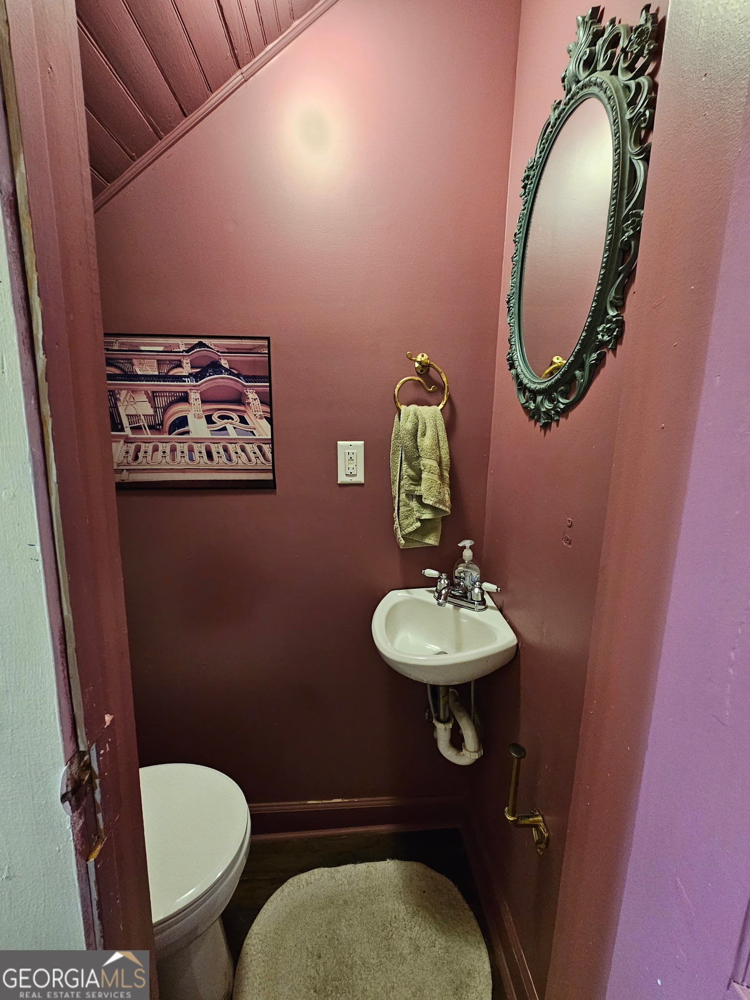 1907 Broad Street Statham, GA 30666 - Photo 10 of 20 a bathroom with a toilet a sink and mirror